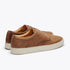 Pair of tobacco brown leather low-top sneakers with white rubber soles and matching laces.