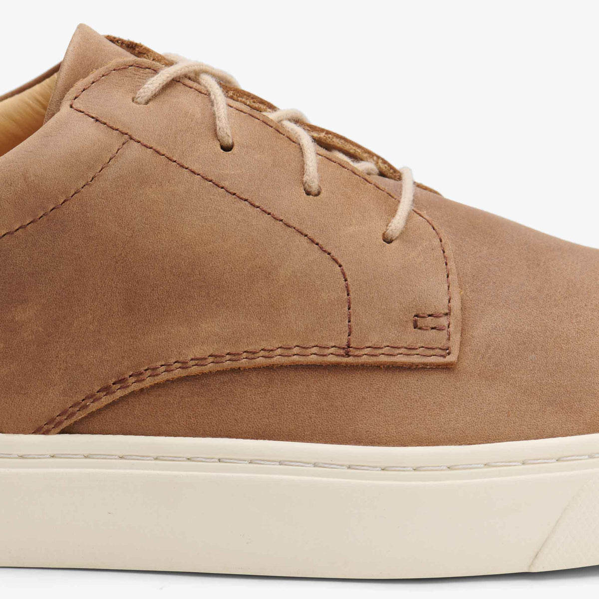 Close-up of a brown leather Diego Everyday Sneaker with tan laces and a thick white rubber sole.