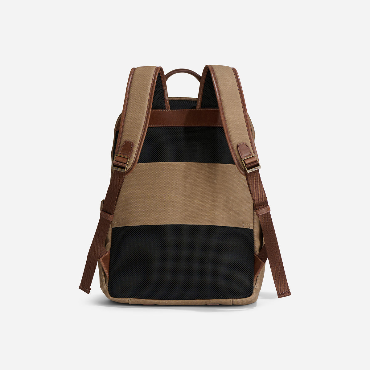 Rear view of a tan waxed canvas backpack with brown leather trim, padded shoulder straps, and black mesh back panels.