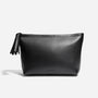 Black leather Petra Pouch with a zipper tassel and the NISOLO brand name printed on the front.