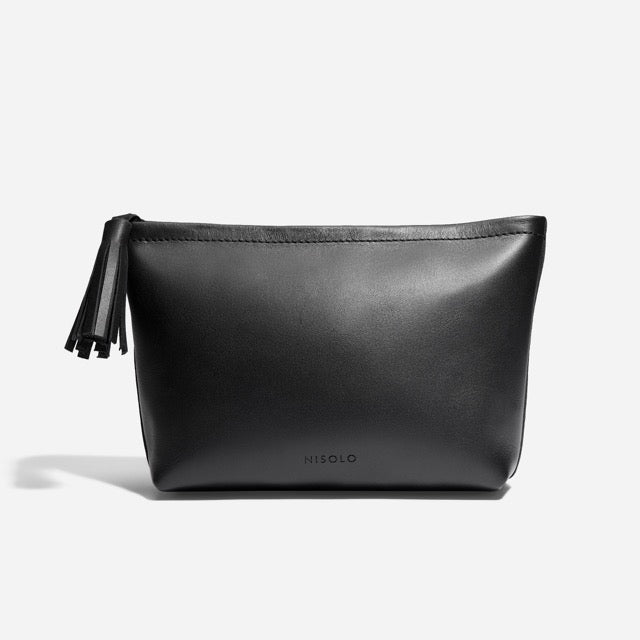 Black leather Petra Pouch with a zipper tassel and the NISOLO brand name printed on the front.