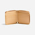Open caramel leather Remi Zip Wallet showing a tan interior with six card slots and a gold-tone perimeter zipper.