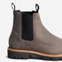 One grey leather Chelsea boot with black elastic side panels, pull tabs, and a lugged rubber sole.