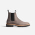 Single grey matte leather Chelsea boot with black elastic side panels and a thick lugged sole on a white background.