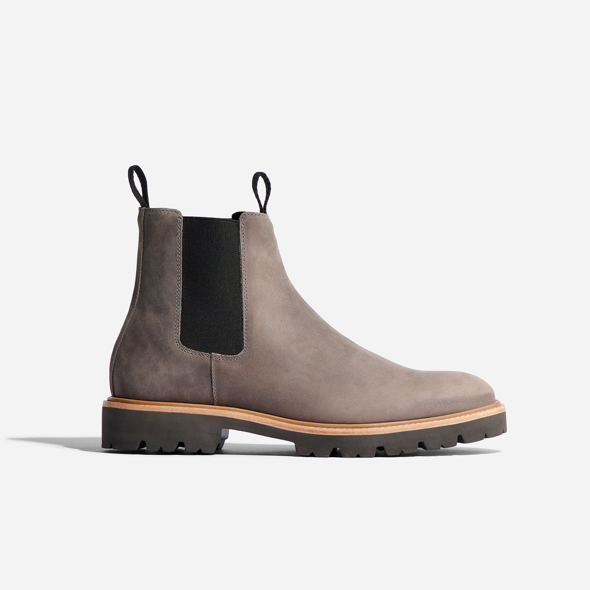 Single grey matte leather Chelsea boot with black elastic side panels and a thick lugged sole on a white background.
