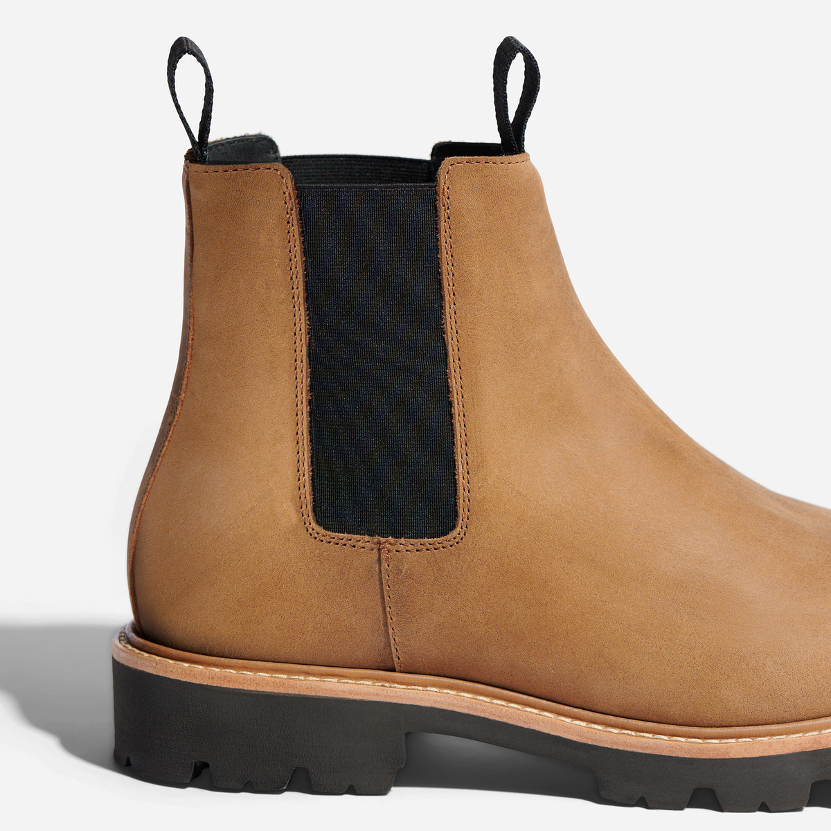 Tobacco brown leather Chelsea boot with black elastic side panels, pull tabs, and a lugged rubber sole.