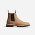 Single tobacco brown leather Chelsea boot with black elastic side panels and a lugged rubber sole.