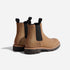 Pair of tobacco brown leather Chelsea boots with black elastic side panels and lugged soles on a white background.
