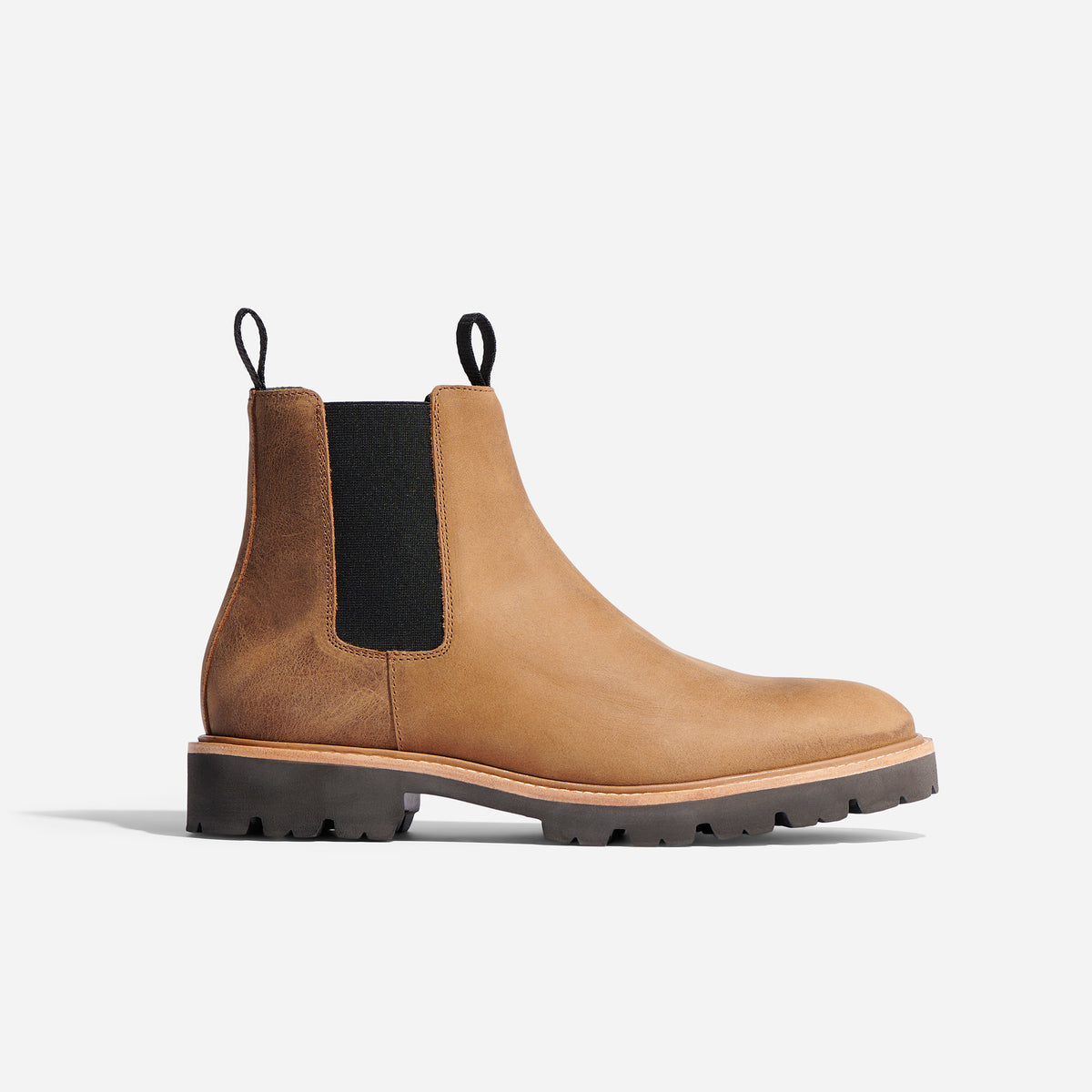 Single tobacco brown leather Chelsea boot with black elastic side panels and a lugged rubber sole.