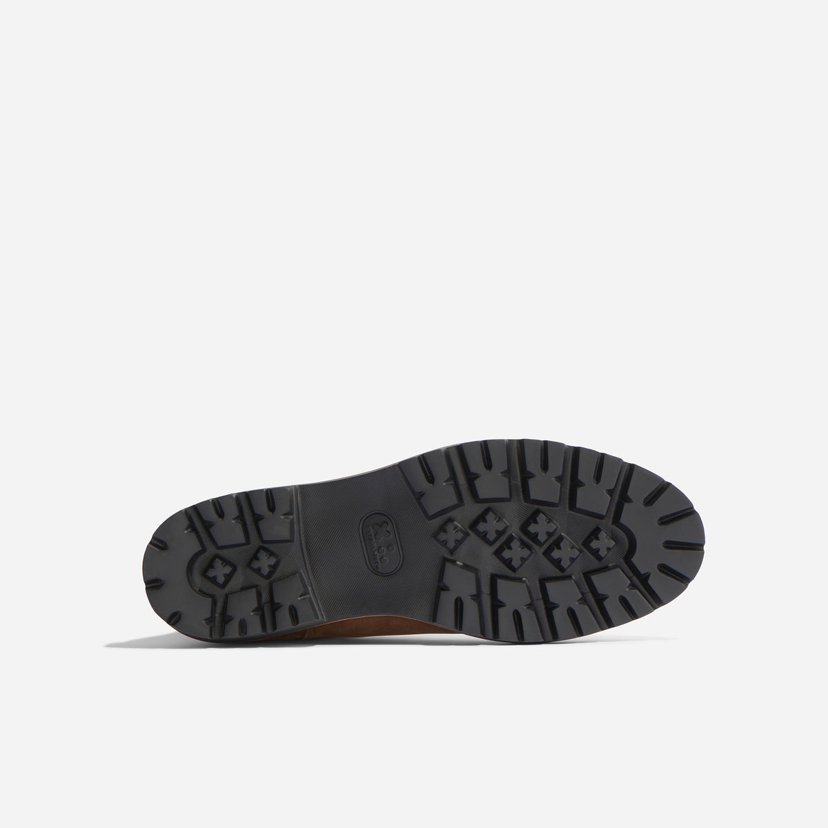 Bottom view of a brown boot showing a black lugged rubber sole with a textured tread pattern and the Nisolo logo.