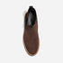 Top view of a single brown suede Chelsea boot with black elastic side panels and NISOLO printed on the black insole.
