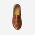 Single brown woven leather Huarache slip on shoe shown from a top-down view with NISOLO printed on the tan inner sole.