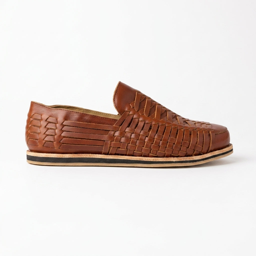 Single brandy brown woven leather slip-on shoe shown from a side profile on a white background.