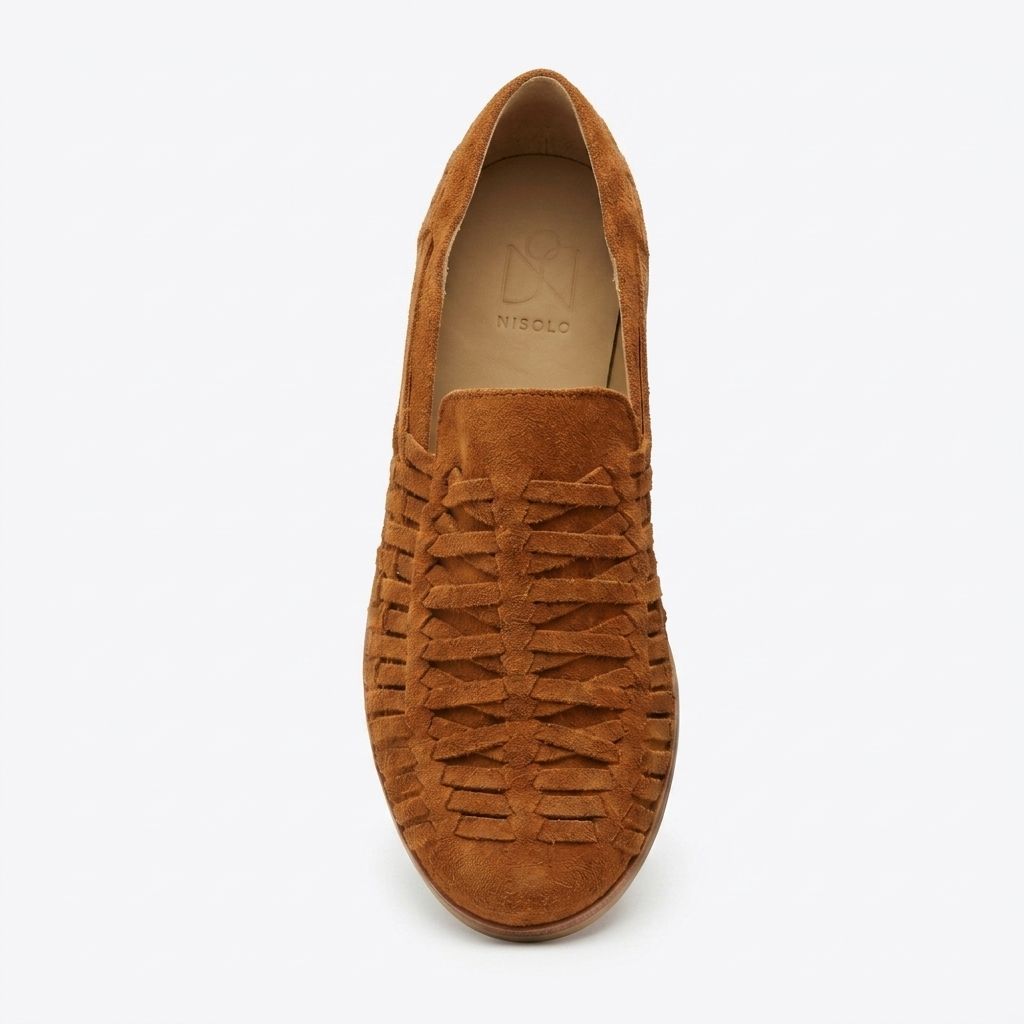 Single terracotta suede woven slip-on shoe with NISOLO printed on the tan interior heel.