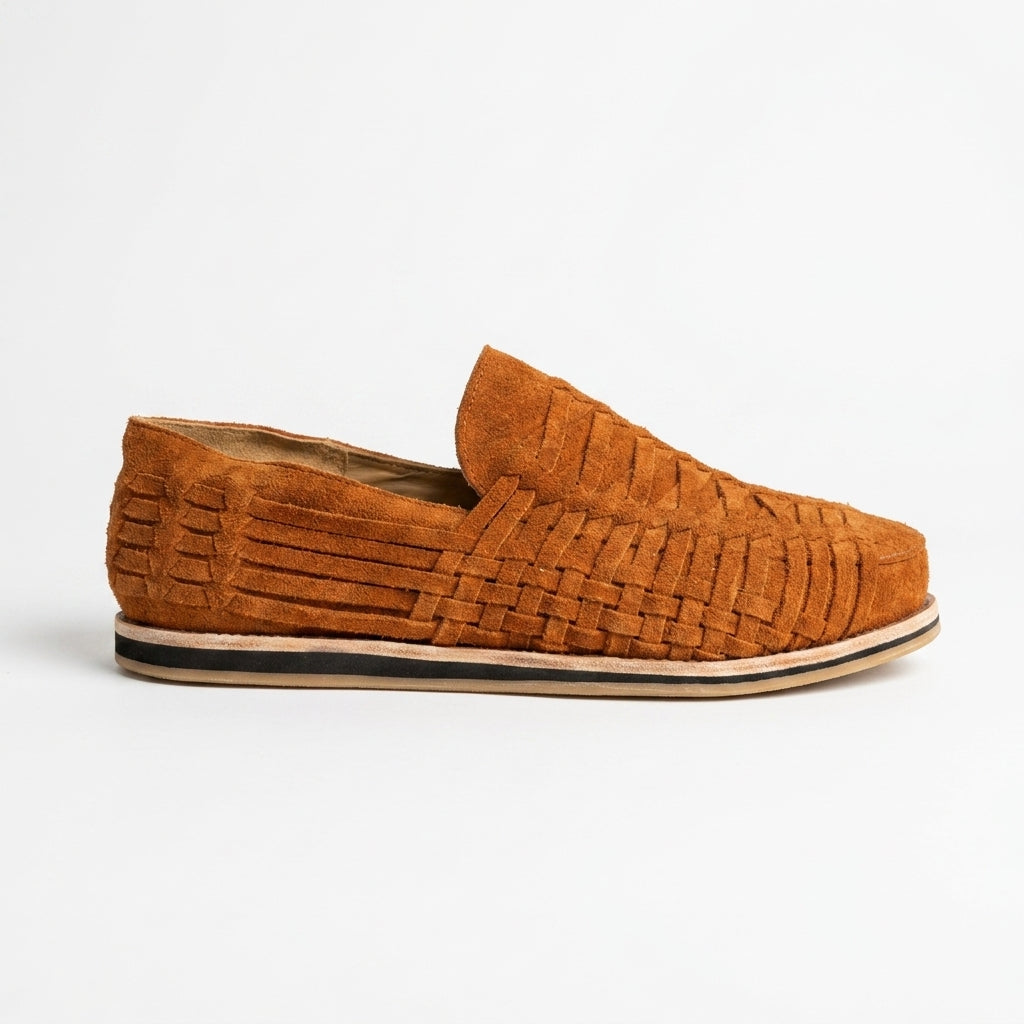 Single terracotta suede woven slip-on shoe shown from a side profile on a white background.
