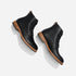 Two black leather lace-up boots with tan soles shown from a top-down angle on a white background.