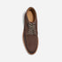 Single umber brown suede moc toe boot with patterned laces and NISOLO printed on the tan inner sole.