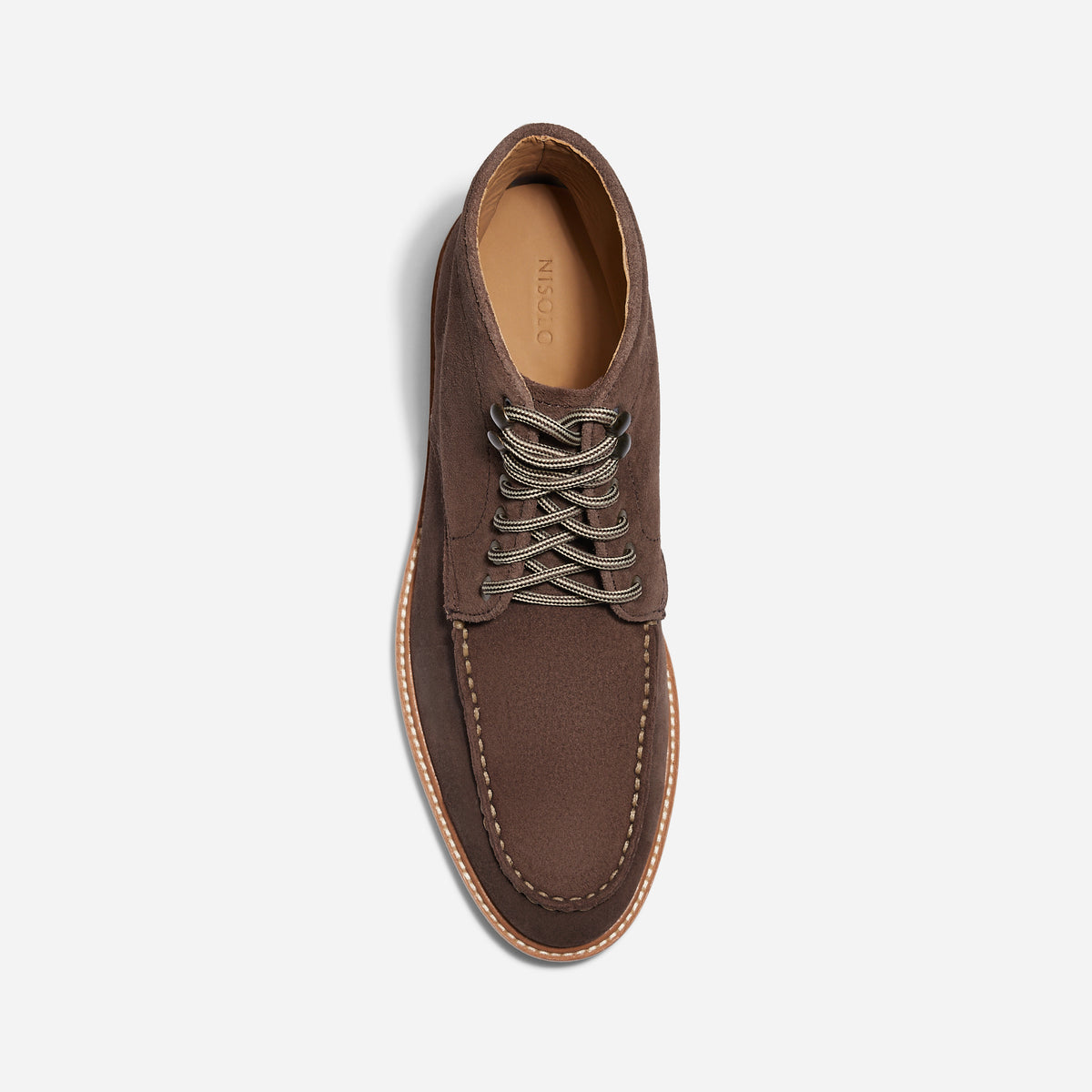Single umber brown suede moc toe boot with patterned laces and NISOLO printed on the tan inner sole.