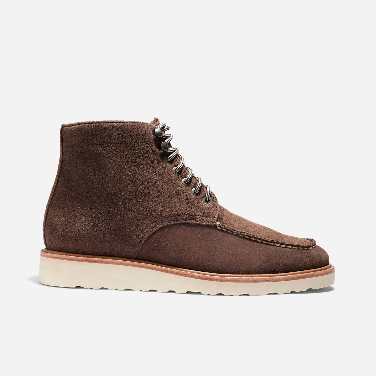 Single umber brown suede Mateo moc toe boot with white wedge sole and striped laces shown from the side profile.