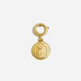 Single gold metal round shoe charm with an embossed logo hanging from a circular clasp.