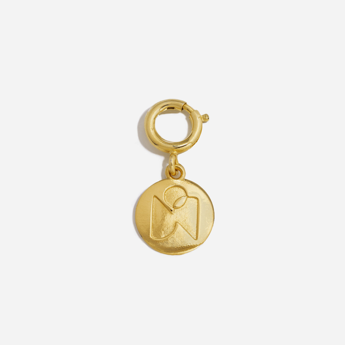 Single gold metal round shoe charm with an embossed logo hanging from a circular clasp.