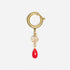 Gold metal ring shoe charm with a clear faceted bead and a red teardrop pendant.