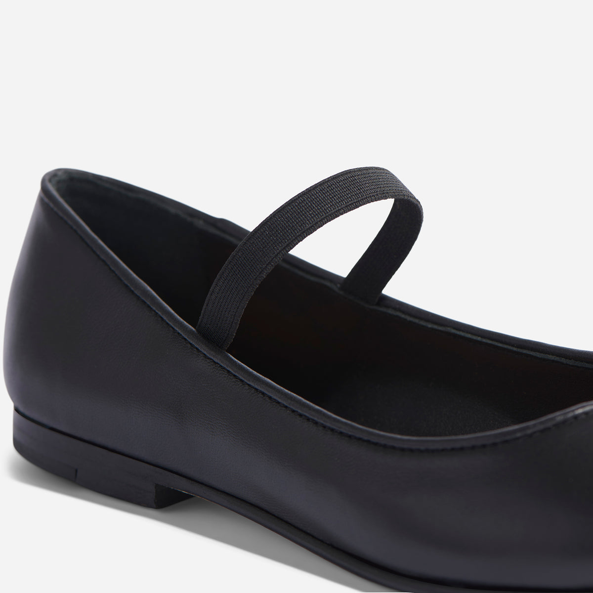Close-up of a black leather Bea Go-To Mary Jane flat featuring a single elastic strap and low heel.