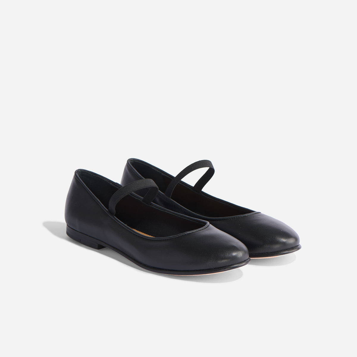 Pair of black leather Bea Go-To Mary Jane flats with round toes and elastic straps on a white background.