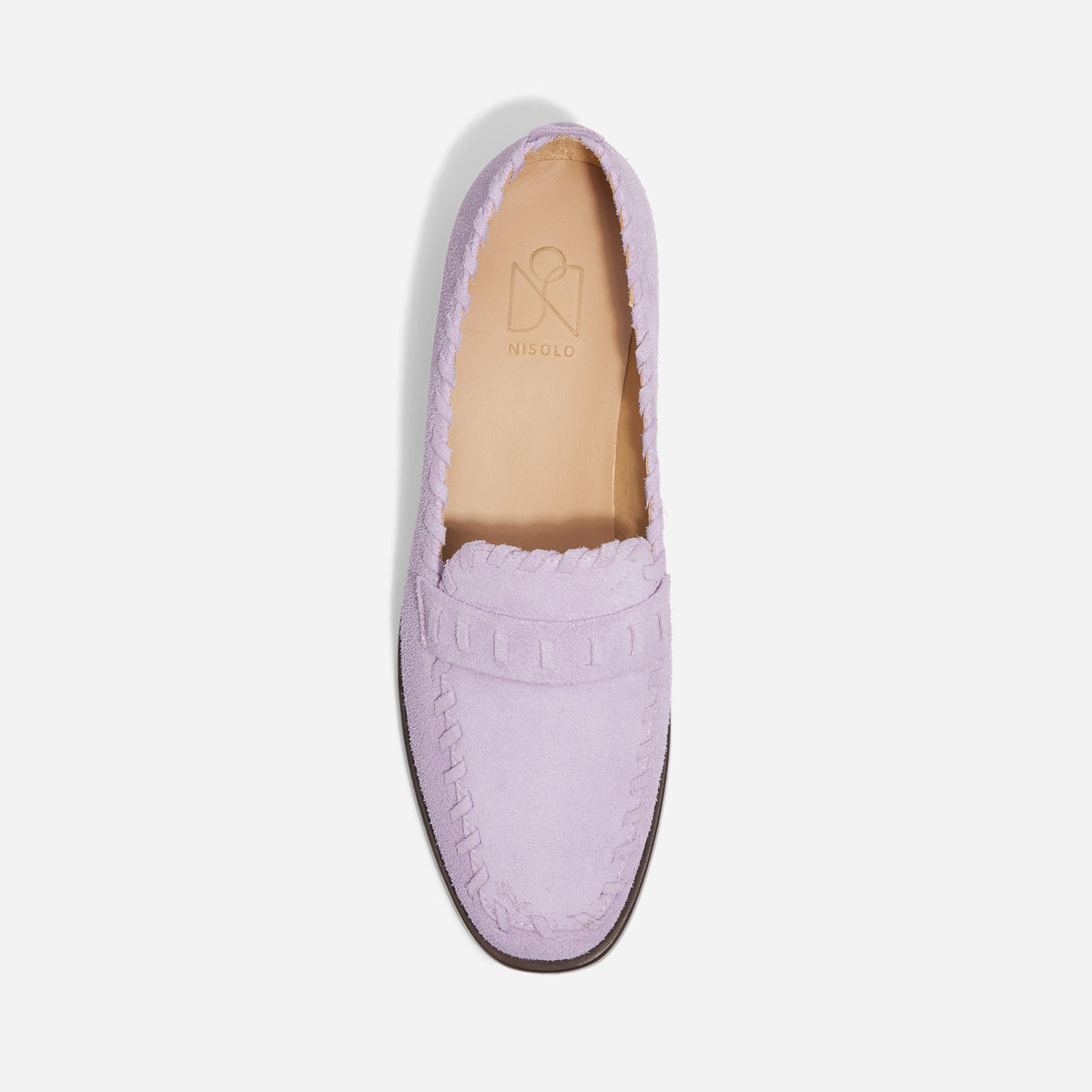 Single lilac suede loafer with whipstitch detailing and NISOLO printed on the tan inner sole.