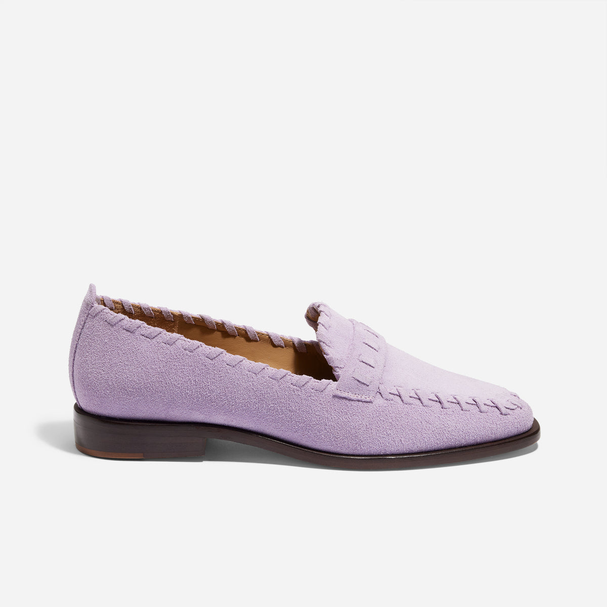 Single lilac suede loafer with whipstitch detailing and a dark brown sole shown from a side profile.