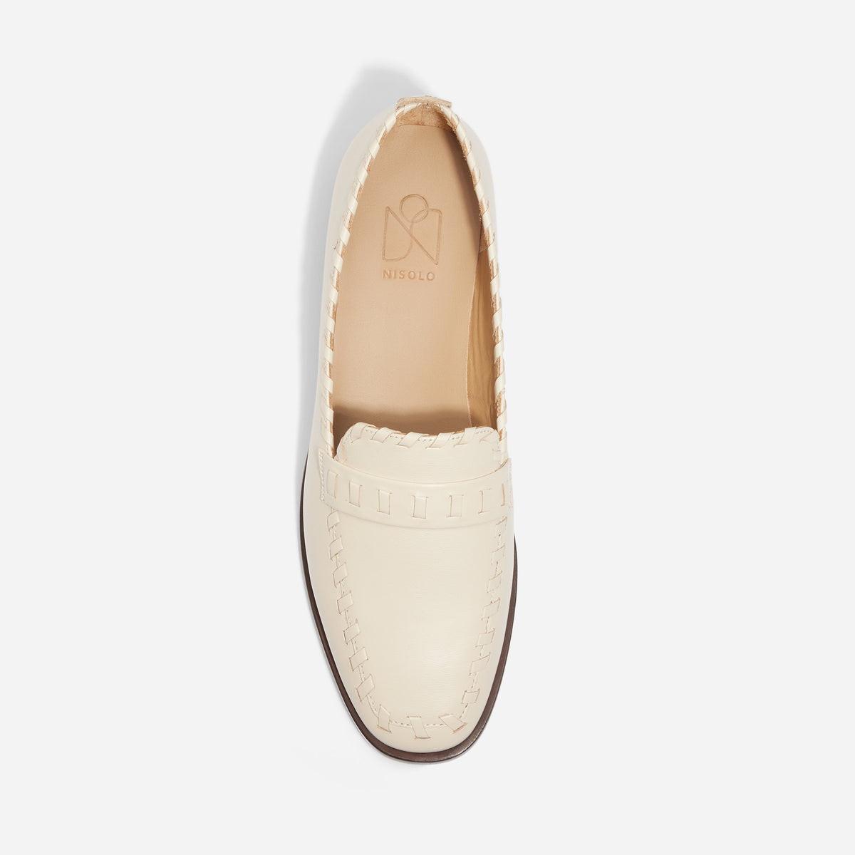 Single off-white leather Lidia Whipstitch Loafer with a round toe and NISOLO printed on the tan insole.