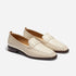 Pair of cream leather Lidia loafers with whipstitch detailing and dark brown soles on a white background.