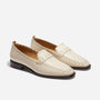 Pair of cream leather Lidia loafers with whipstitch detailing and dark brown soles on a white background.