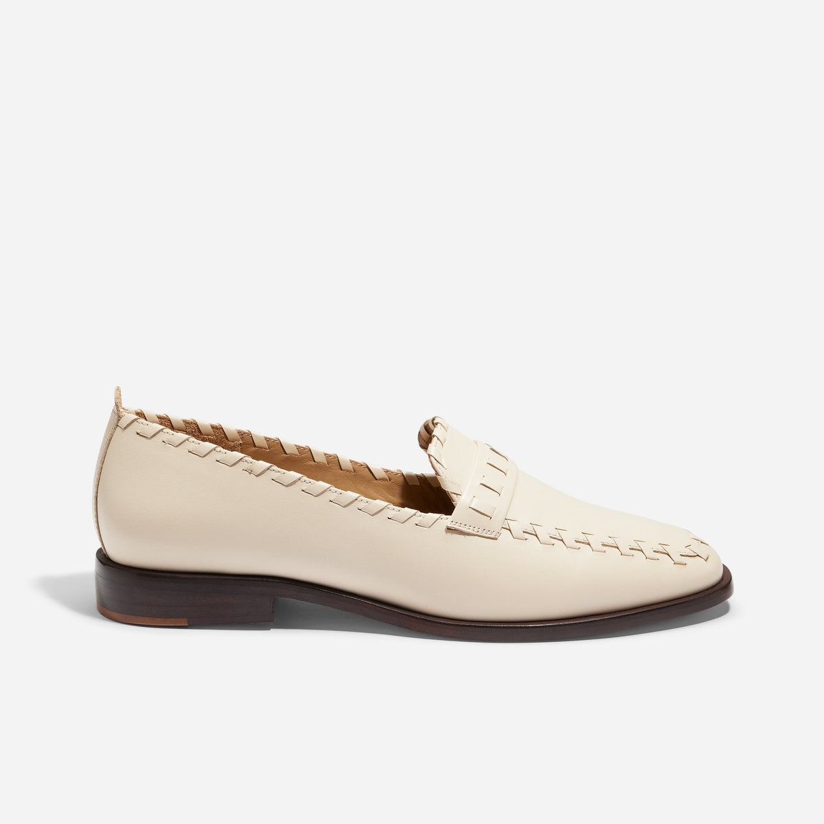 Single pearl leather loafer with whipstitch detailing and a dark brown sole shown in profile against a white background.