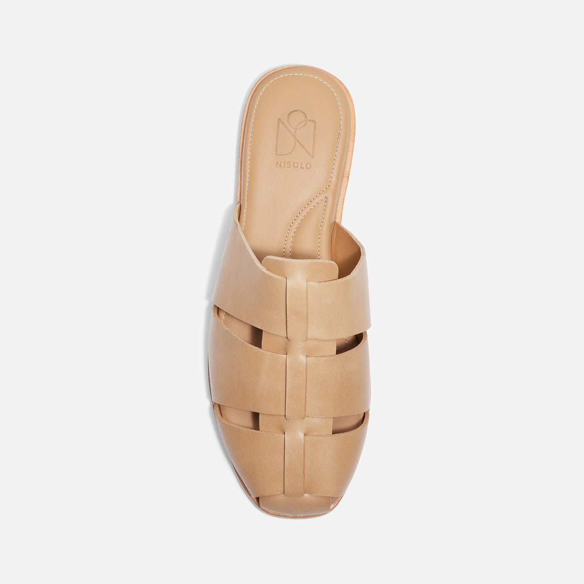 Single almond leather fisherman mule with a woven caged upper and NISOLO printed on the footbed.