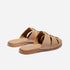 Pair of tan leather fisherman mules with woven straps and flat soles, featuring the NISOLO logo on the footbed.