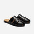 Pair of black leather fisherman mules with woven straps and tan insoles featuring the NISOLO logo.
