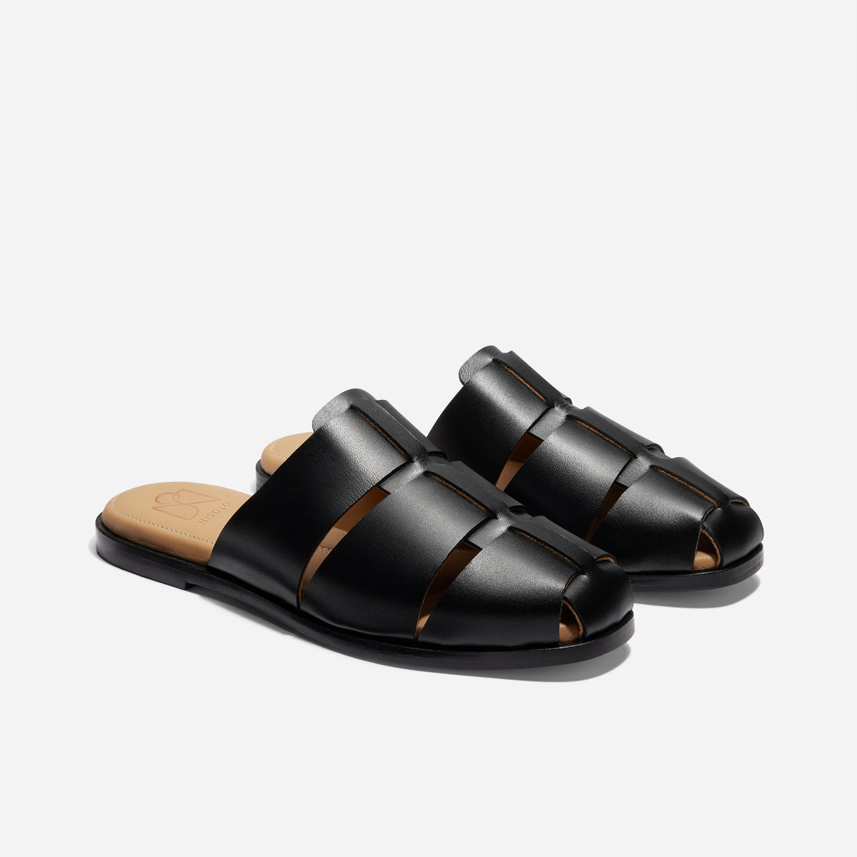 Pair of black leather fisherman mules with woven straps and tan insoles featuring the NISOLO logo.
