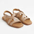Pair of almond tan leather sandals with crisscross straps and adjustable ankle buckles on a white background.