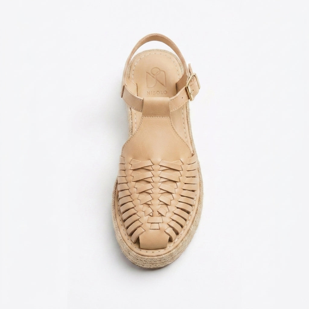 Single almond leather T-strap huarache sandal with woven toe, jute espadrille sole, and Nisolo logo on the heel.