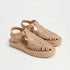 Pair of almond leather Huarache T-strap sandals with woven toes and jute espadrille platform soles.