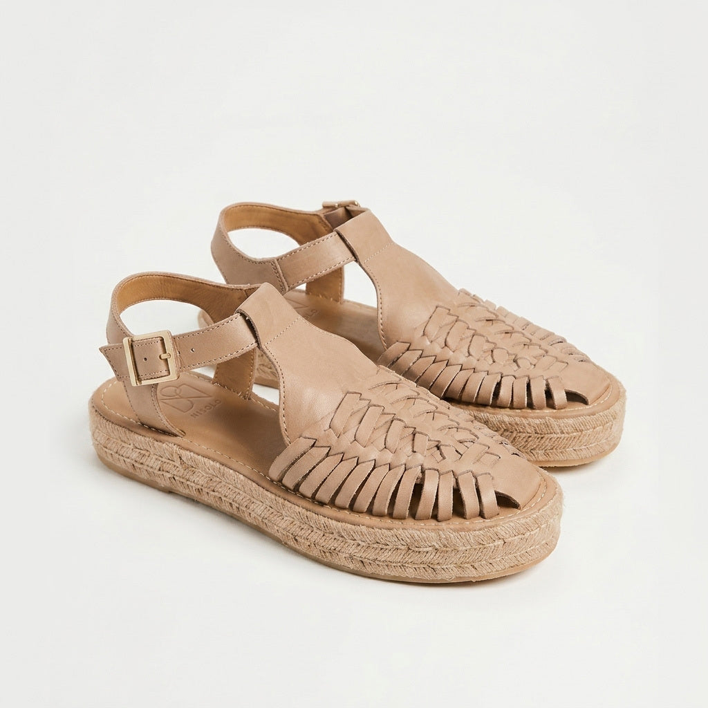Pair of almond leather Huarache T-strap sandals with woven toes and jute espadrille platform soles.