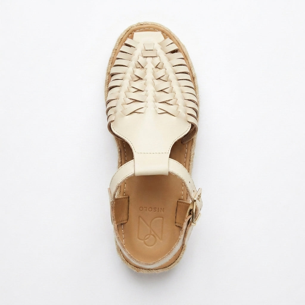 Single bone white woven leather Huarache T-Strap Espadrille Sandal with a jute sole and NISOLO printed on the heel.