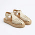 Pair of bone leather huarache T-strap sandals with woven toes, gold buckles, and jute espadrille soles. NISOLO printed on ...