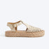 Bone leather huarache T-strap sandal with a woven toe, gold buckle, and jute espadrille platform sole.