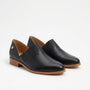Pair of black leather slip-on oxford shoes with pleated fabric details and tan wood-tone soles on a white background.
