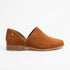 Single terracotta suede slip-on oxford shoe with side cutouts and a low wood-look heel on a white background.