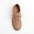 Single tan woven leather bootie with laces and NISOLO printed on the inner sole, viewed from above on a white background.