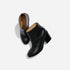 Two black leather ankle boots with block heels and tan interior, featuring the NISOLO logo on the insole.