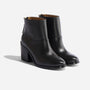 Pair of black leather ankle boots with a block heel and round toe, shown from a side angle on a white background.